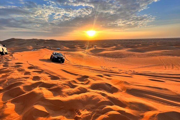 A four-by-four on the dunes at sunset