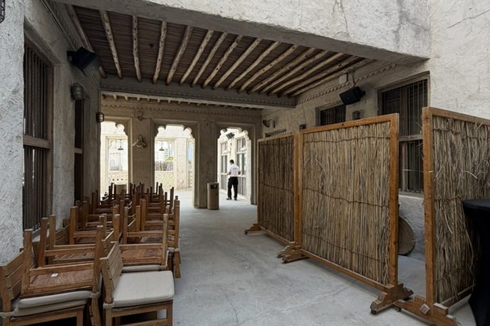 Seating under a timber roof beside reed screens