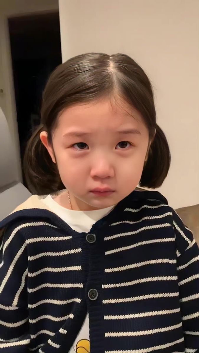 A small child with a wobbling lip, close to tears